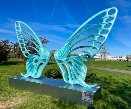 Name: Dream Machine II
 Medium: Painted 
Fiberglass Sculpture with stainless structure and Base.
 Size: 13’ x 4’ x 9’5 ( Wings + Base).
 Year: 2019