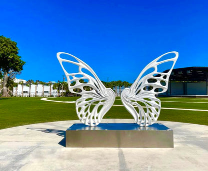 Name: Dream Machine I 
 Medium: Painted 
Fiberglass Sculpture with stainless structure and Base.
 Size: 13’ x 4’ x 9’5 ( Wings + Base).
 Year: 2017