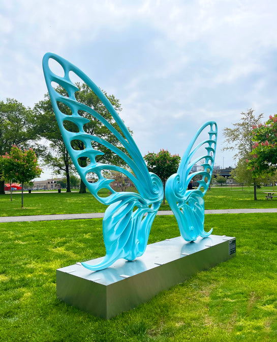 Name: Dream Machine II
 Medium: Painted 
Fiberglass Sculpture with stainless structure and Base.
 Size: 13’ x 4’ x 9’5 ( Wings + Base).
 Year: 2019