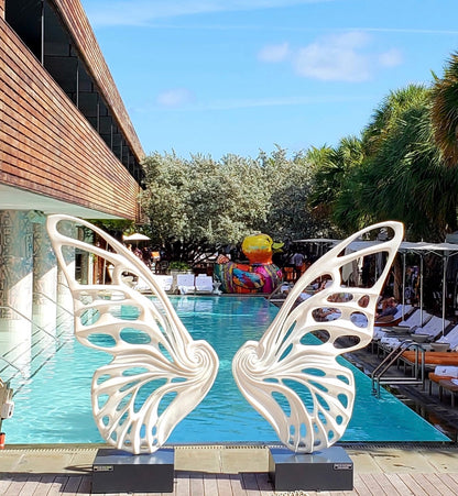 Name: Dream Machine I 
 Medium: Painted 
Fiberglass Sculpture with stainless structure and Base.
 Size: 13’ x 4’ x 9’5 ( Wings + Base).
 Year: 2017