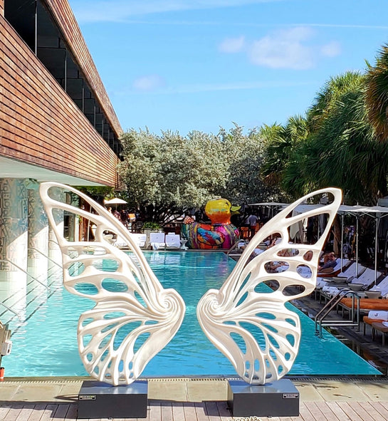 Name: Dream Machine I 
 Medium: Painted 
Fiberglass Sculpture with stainless structure and Base.
 Size: 13’ x 4’ x 9’5 ( Wings + Base).
 Year: 2017