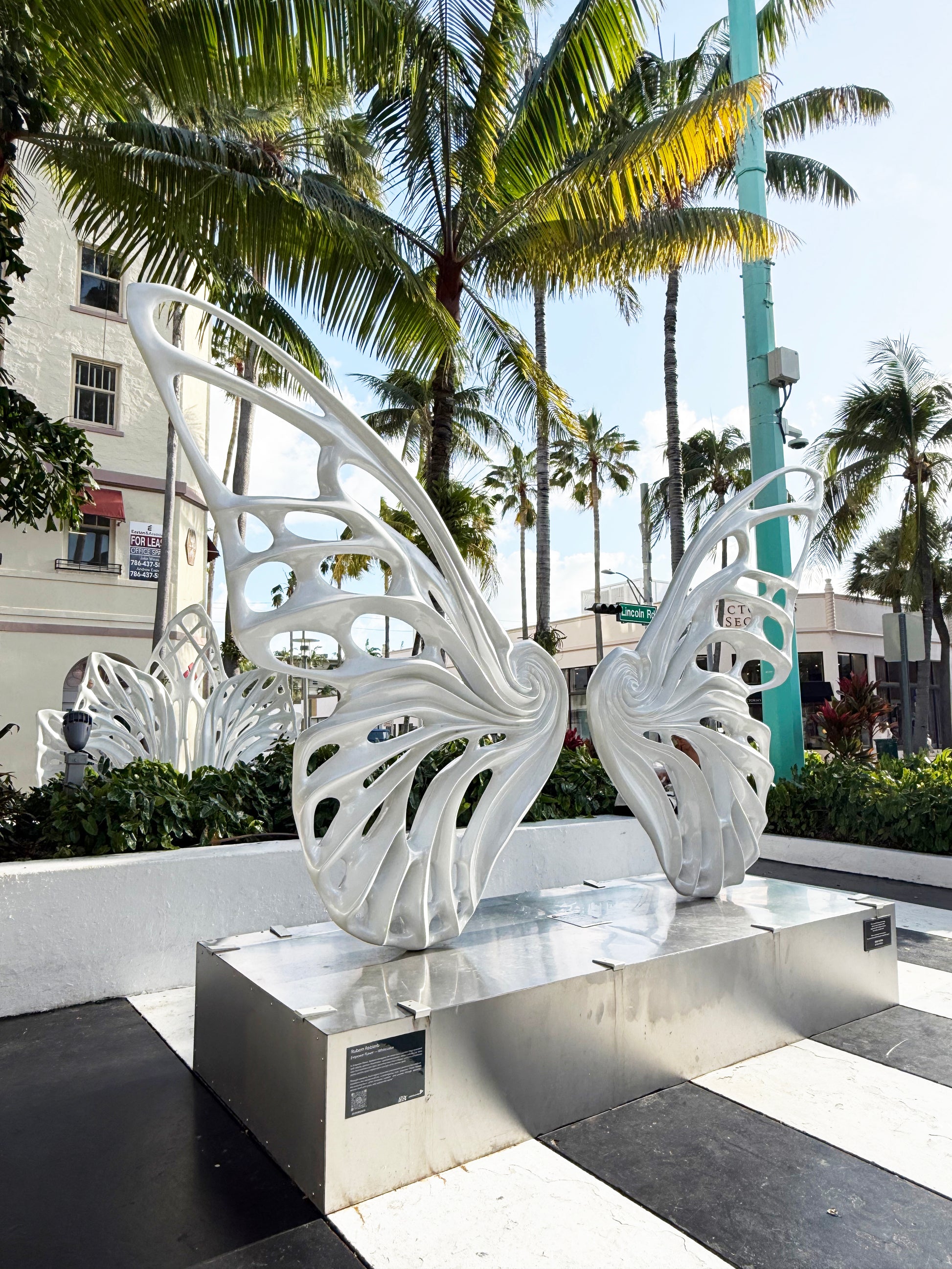 Name: Dream Machine I 
 Medium: Painted 
Fiberglass Sculpture with stainless structure and Base.
 Size: 13’ x 4’ x 9’5 ( Wings + Base).
 Year: 2017