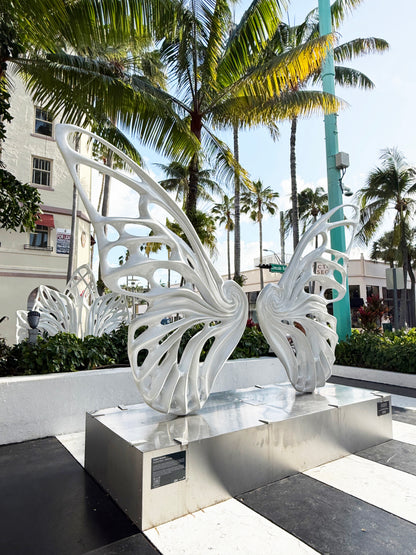 Name: Dream Machine I 
 Medium: Painted 
Fiberglass Sculpture with stainless structure and Base.
 Size: 13’ x 4’ x 9’5 ( Wings + Base).
 Year: 2017