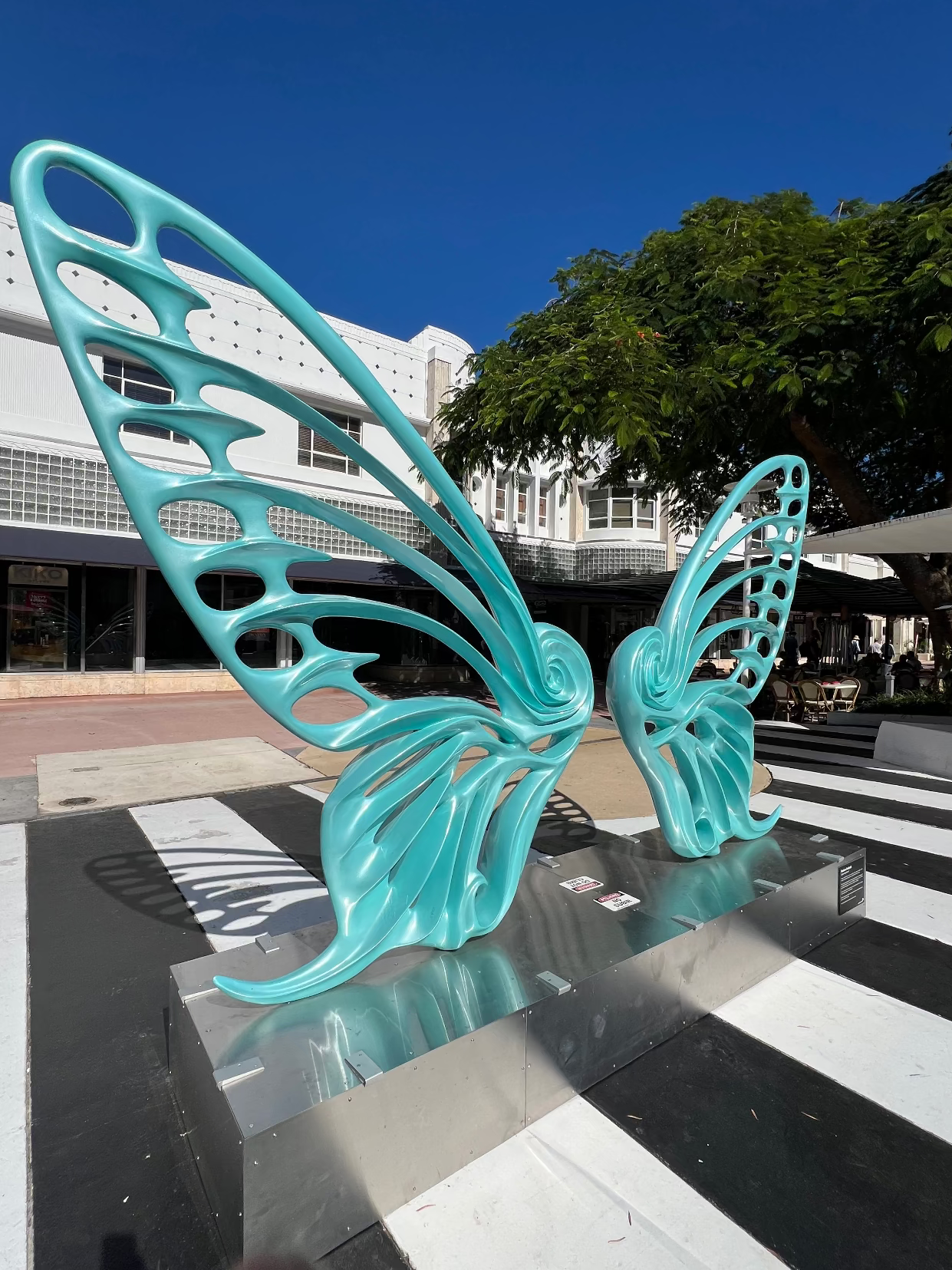 Name: Dream Machine II
 Medium: Painted 
Fiberglass Sculpture with stainless structure and Base.
 Size: 13’ x 4’ x 9’5 ( Wings + Base).
 Year: 2019